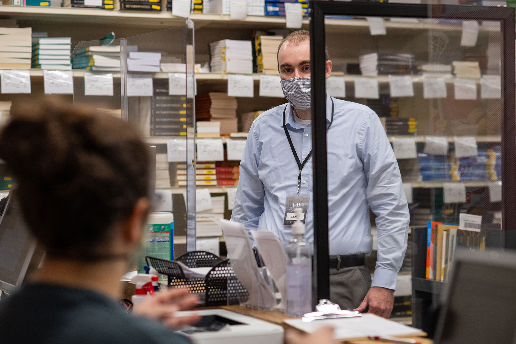 A photo of Kurt Mahnke (CAS’04) behind the counter at Barnes and Nobles at BU