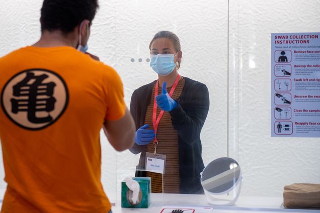 Collection site specialist Jessica Sandberg guides a visitor through the test collection process at the Rajen Kilachand Center August 25, 2020. According to the BU COVID-19 Testing Data Dashboard there have been 14965 tests administered as of August 23, 25 of which are positive.