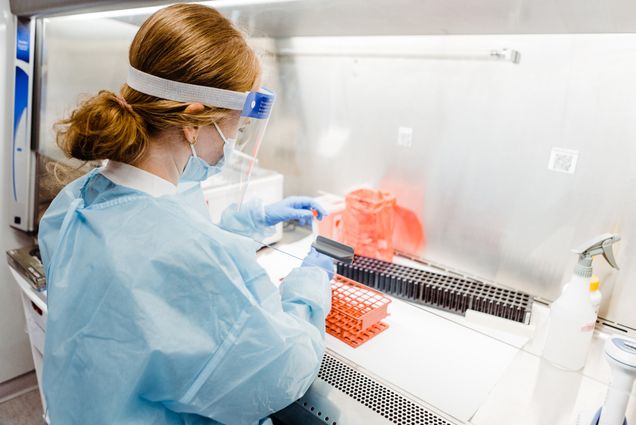 A photo of someone working in the he Covid-19 testing lab at Kilachand Center