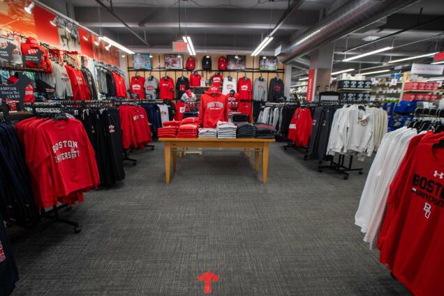 Photo of the BU merchandise section of Barnes and Nobles on August 19. A directional sign on the floor in red tape directs traffic.