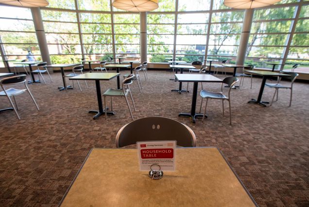 COVID-19 safety signage on a BU dining hall table