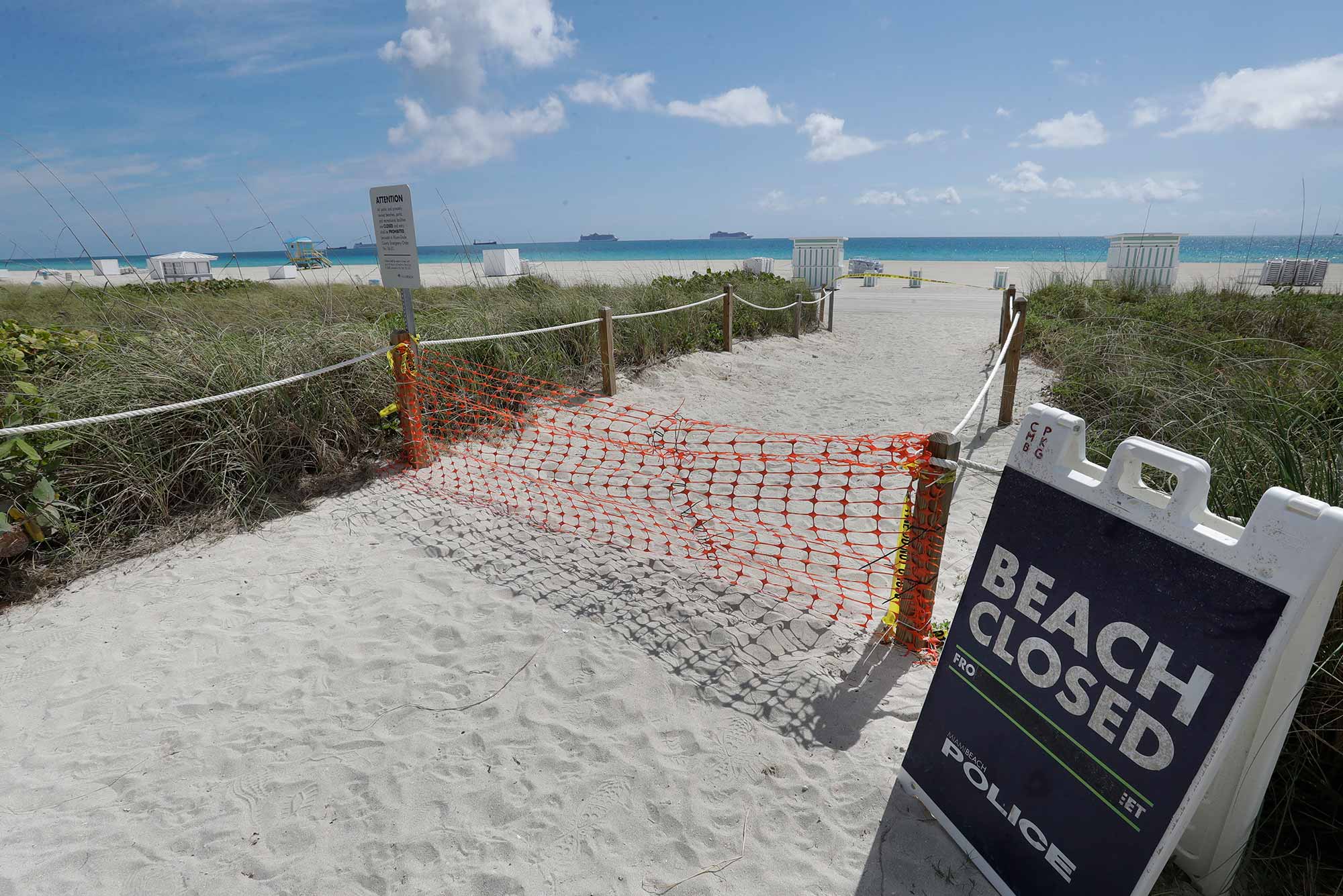 A photo of a "beach closed" sign on Miami Beach