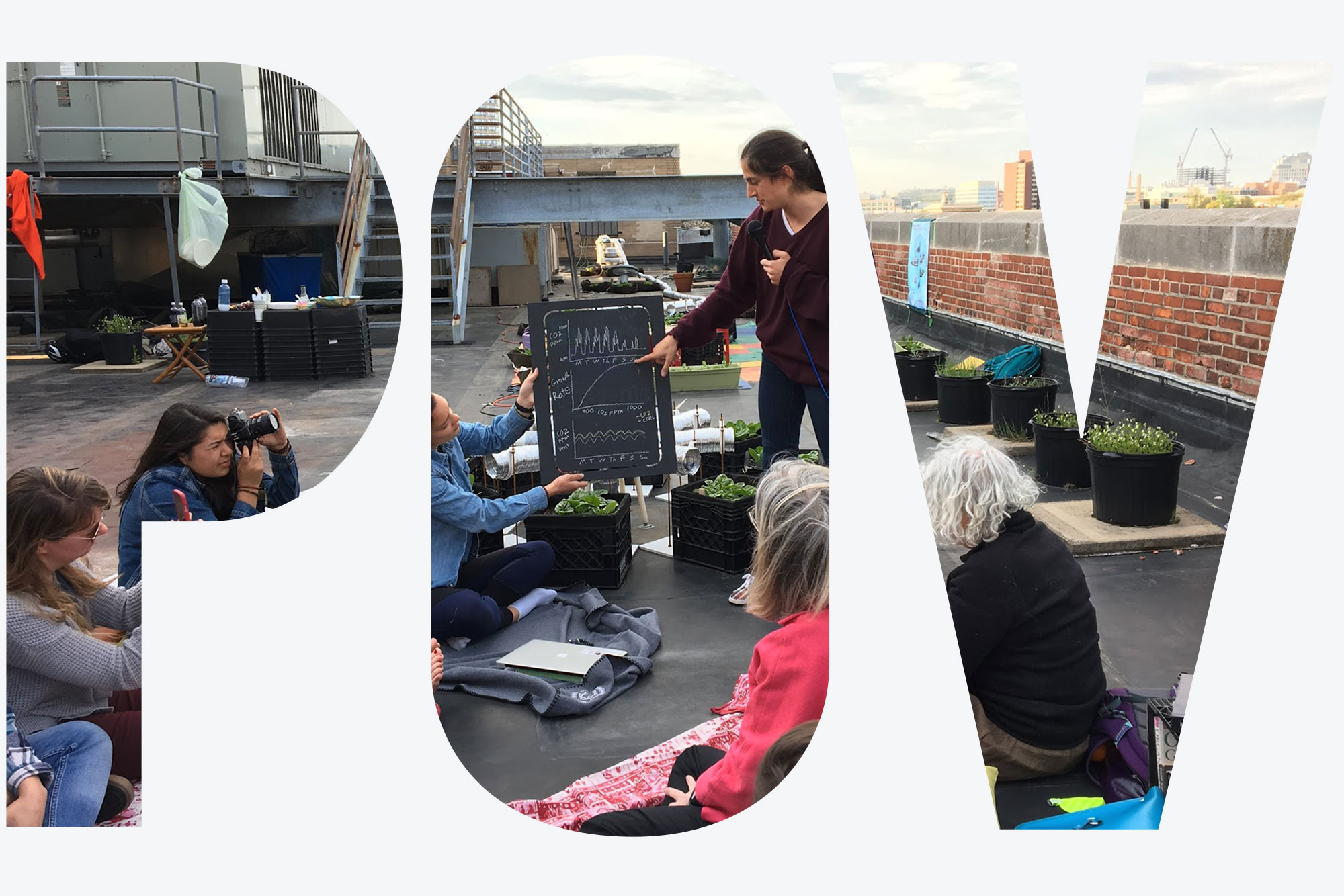 Photo of Dr. Sarabeth Buckley teaching about the urban carbon cycle in a circle of students sitting atop a roof. The students sit on the rooftop, while the Boston skyline is see in the background. Sarabeth wears a purple sweater and gestures towards a small chalkboard with charts. Overlay reads 'POV'