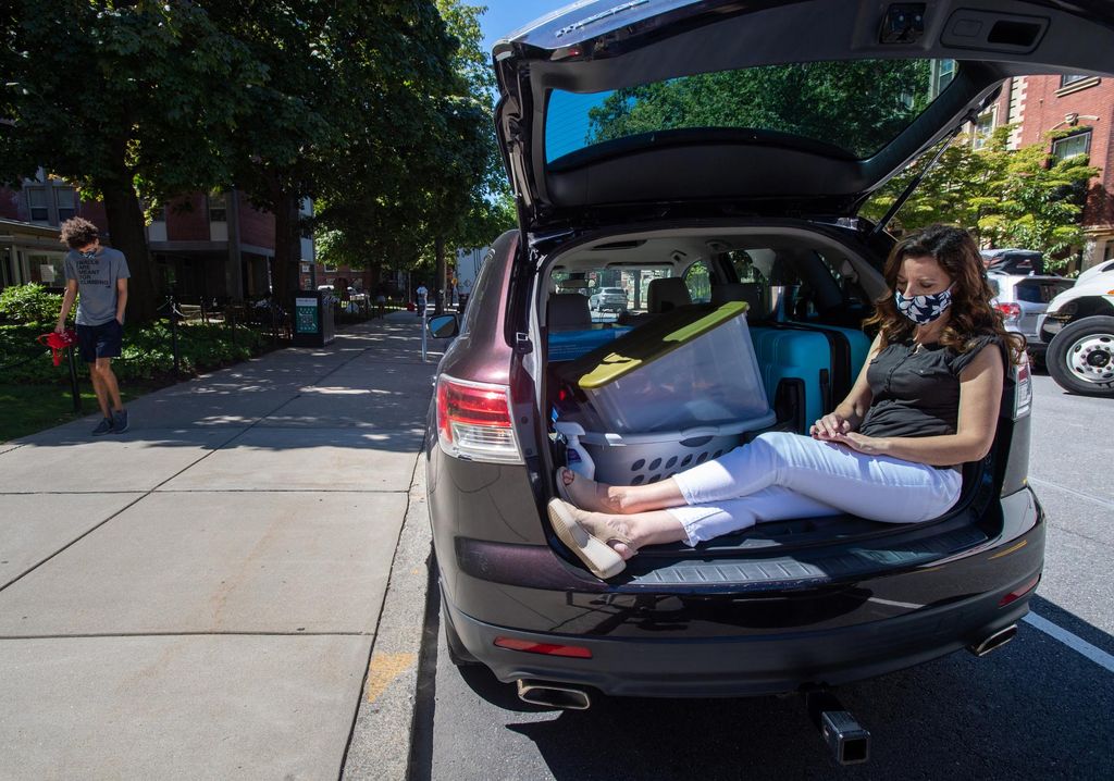 Since only one person could help students move into their dorms this year, Claudia Ibarra soaked up some sun while her husband and their son, Eric Ibarra (CAS’24), schlepped Eric’s belongings into The Towers. Claudia sits cross-legged underneath the shade of the back hatch of a car filled with belongings to be moved.