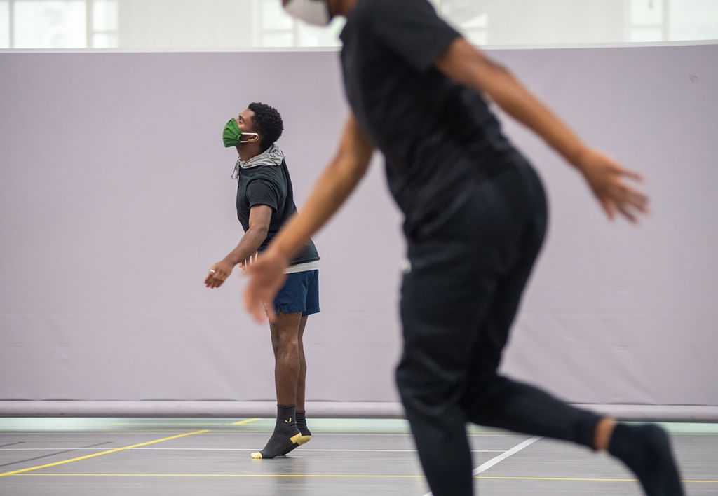 Photo of John Tomlinson (CFA’21) (left) moves within his 14-foot square during Liz Roncka’s improv dance class at FitRec, September 3. In the foreground, another student dressed in black is seen dancing as well.