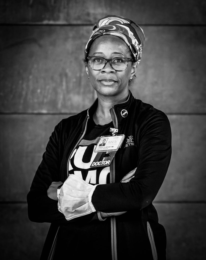 Black and white portrait of Vonzella Bryant, BMC emergency medical physician, and MED director of medical student education, assistant dean of student affairs, and clinical assistant professor of emergency medicine. She stands with her arms across her chest in a dark jacket.