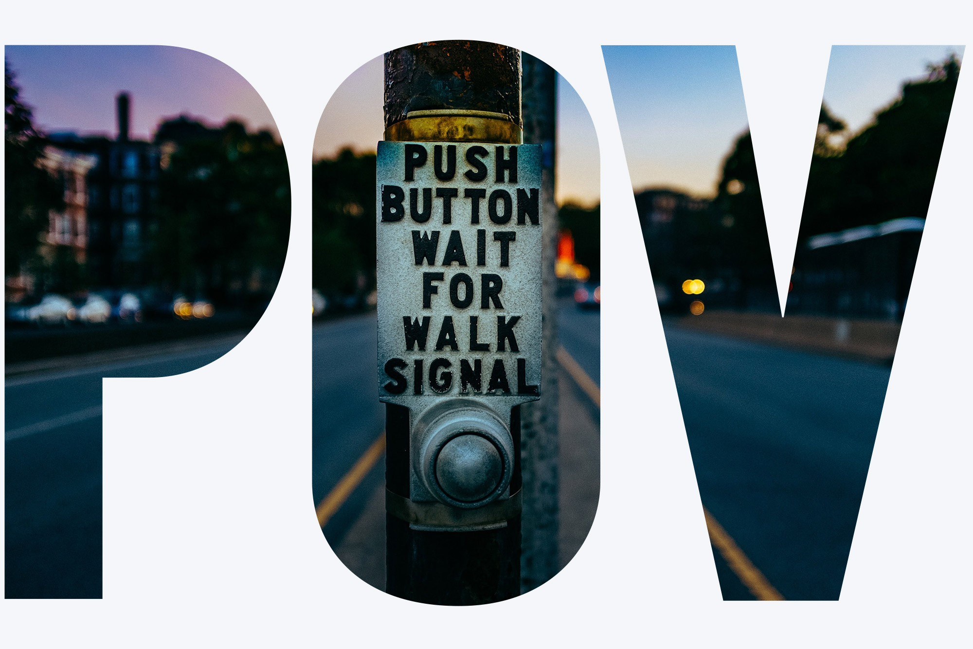 Detail photo of a Walk Signal Button at a crosswalk in Boston at dusk.