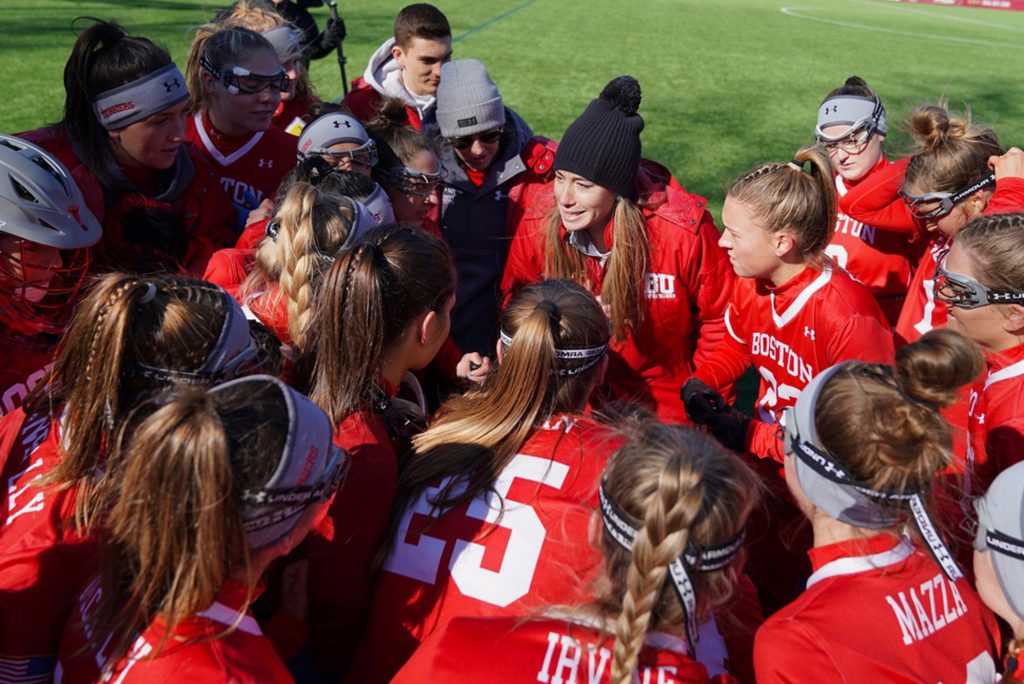A photo of Lauren Morton in the huddle with the BU field hockey team