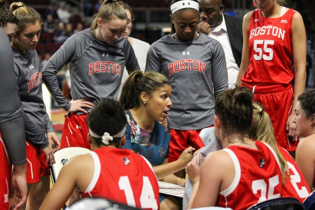 A photo of Marisa Moseley in a huddle with the BU women's basketball team