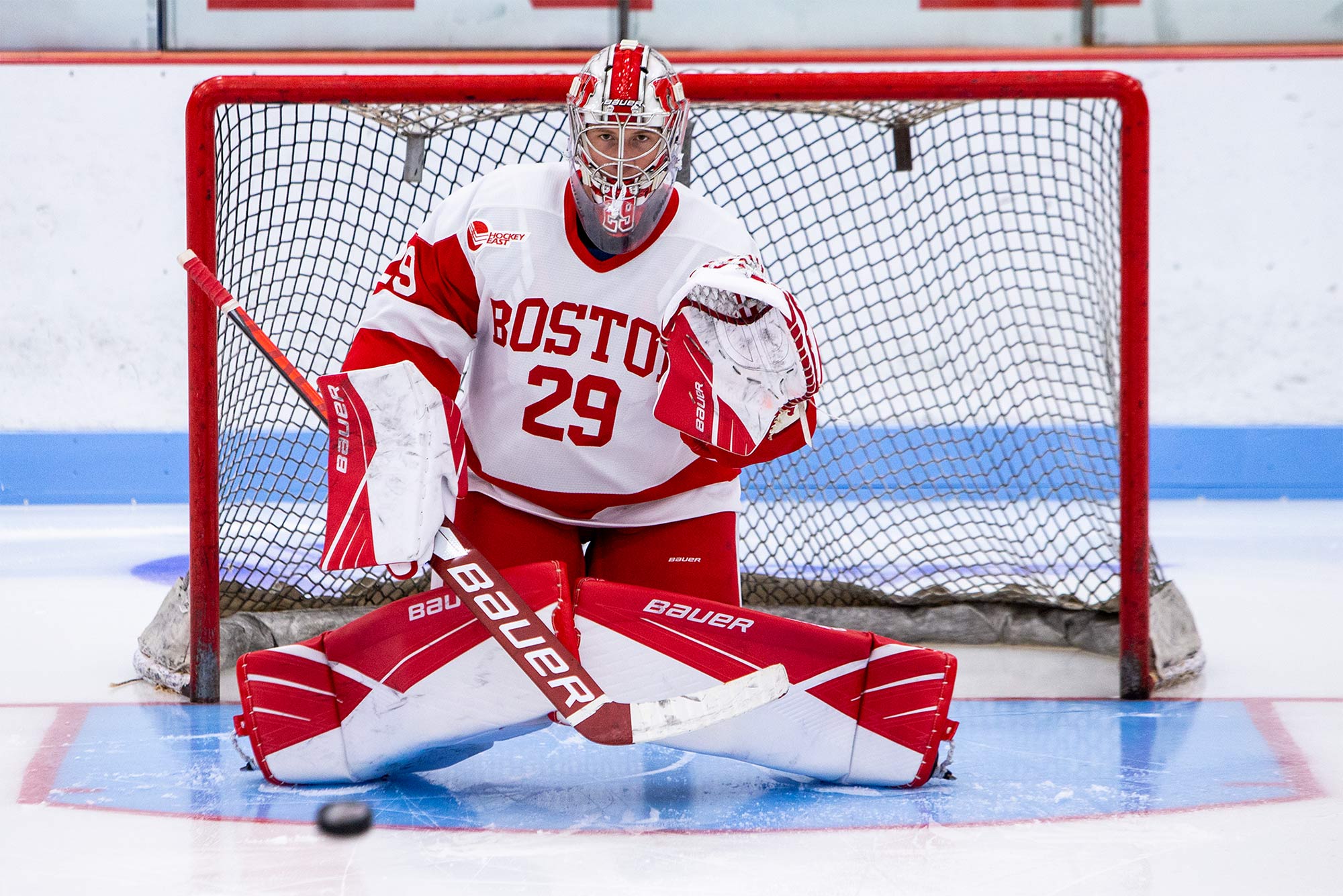 Photo of Drew Commesso (number 29) standing in the net playing goalie in his BU jersey.