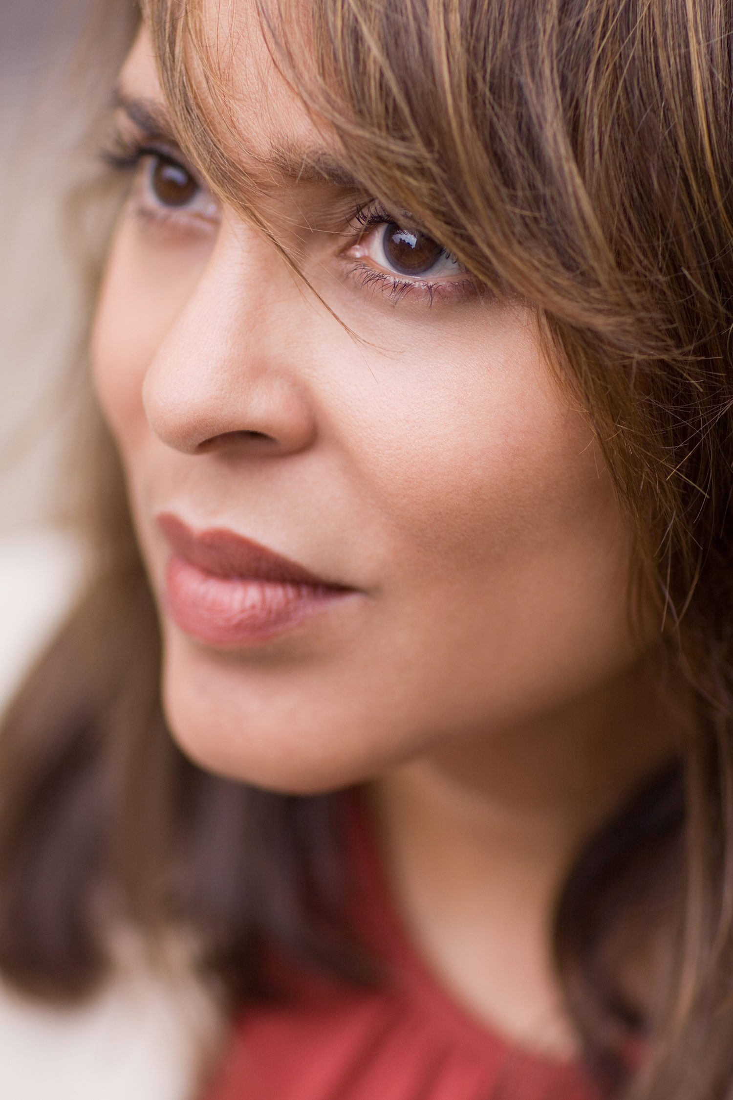 Closeup portrait of poet Natasha Trethewey, her bangs sway to the right over her eyes. Photo by Matt Valentine