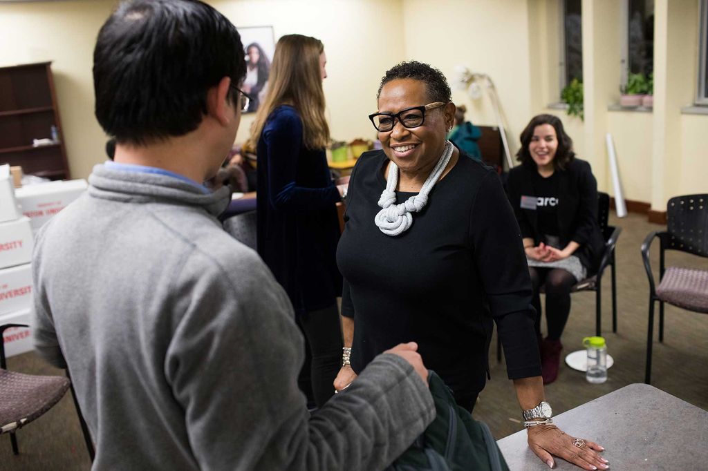 Director of the Howard Thurman Center, Katherine Kennedy chats with a student interested in checking out what the Howard Thurman Center has to offer during the grand closing of the old Howard Thurman Center location in the George Sherman Union building Wednesday, December 11, 2019.
