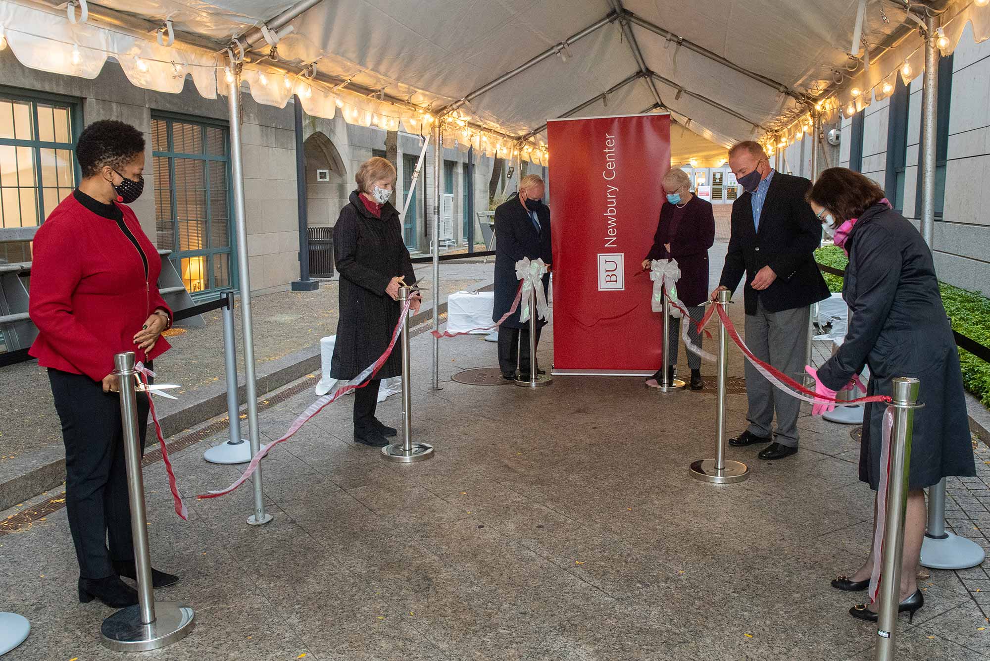 Members of Boston University administration and former trustees of Newbury College cut the ribbon to officially open the Newbury Center at Boston University which will support first generation students