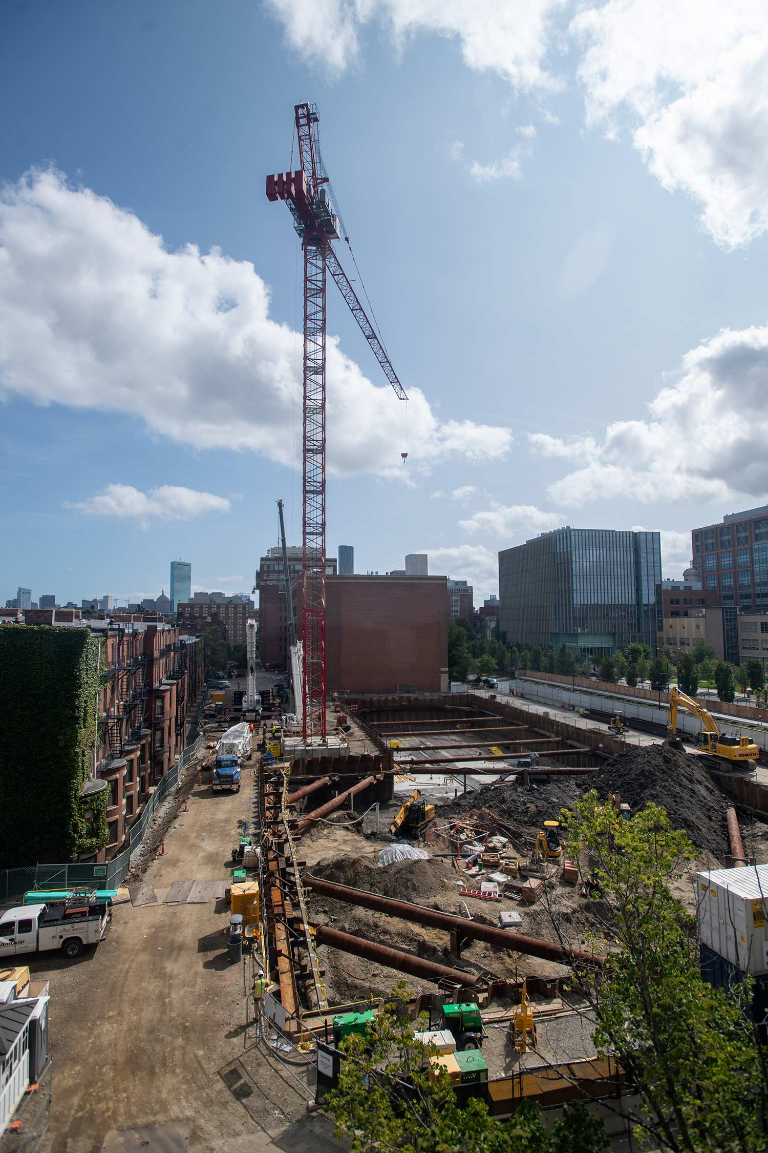 Photo of construction at Data Services Center, including the addition of a massive crane September 13. The sky is bright and has white fluffy clouds.