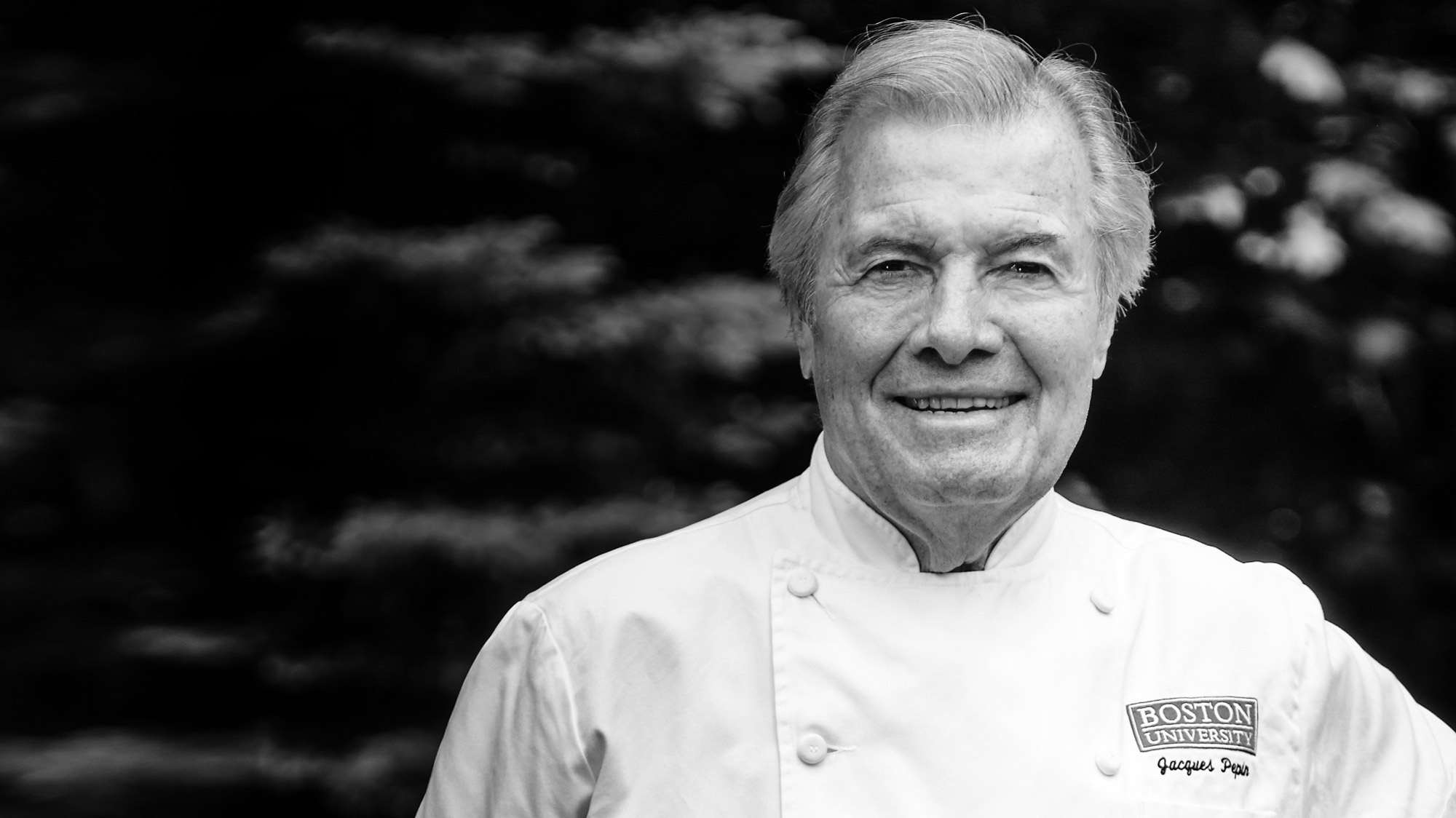 A portrait photo of chef Jacques Pepin in black and white