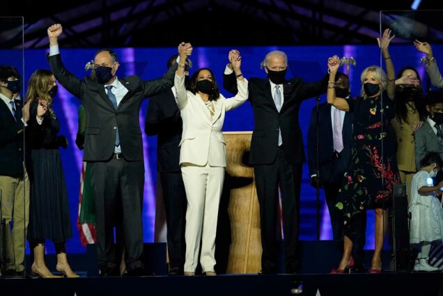 Doug Emhoff, Vice President-elect Kamala Harris, President-elect Joe Biden and his wife Jill Biden raise their hands in victory on stage together, Saturday, Nov. 7, 2020, in Wilmington, Del.