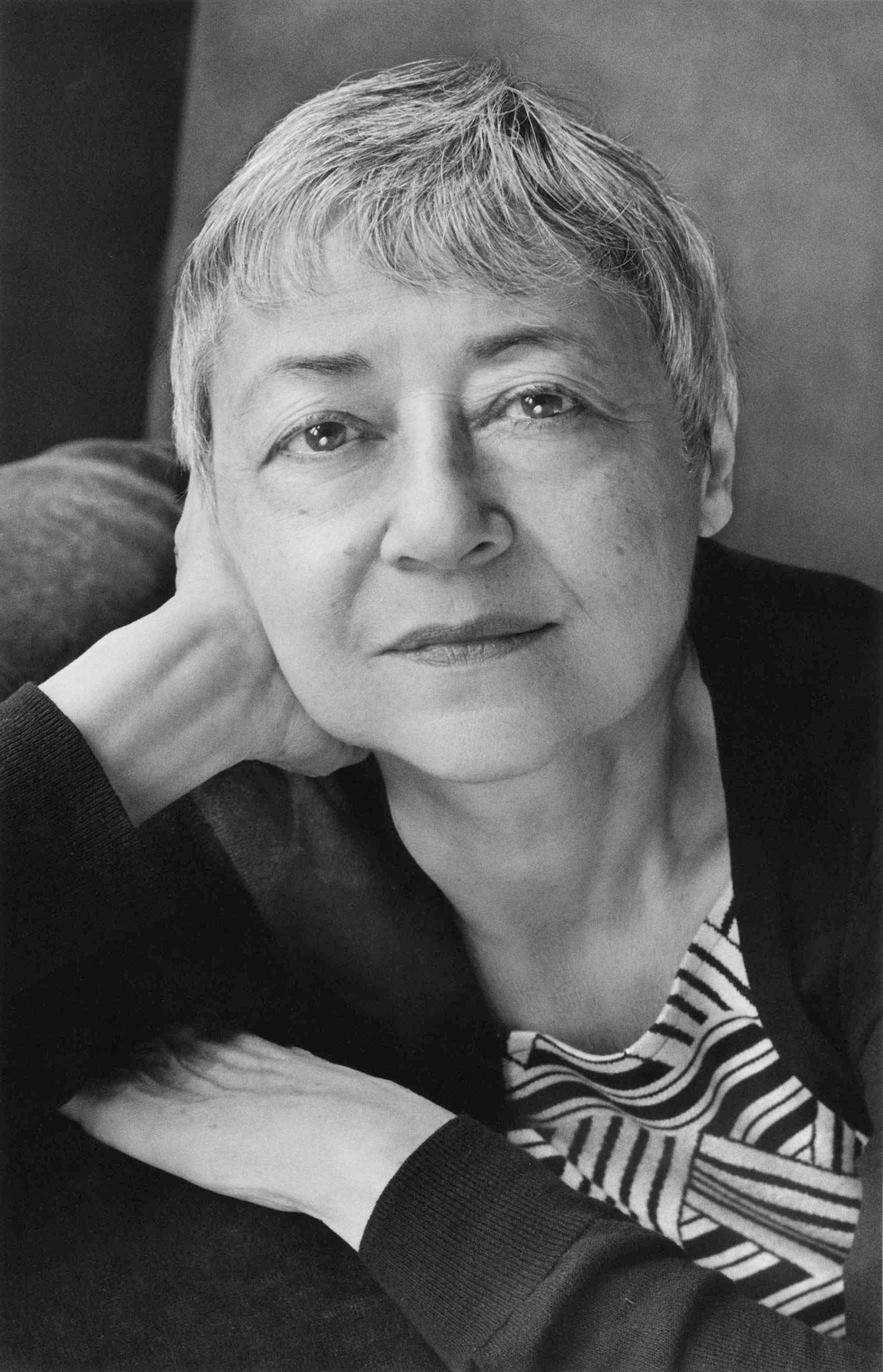 Black and white portrait of Sigrid Nunez with her hand on her face.