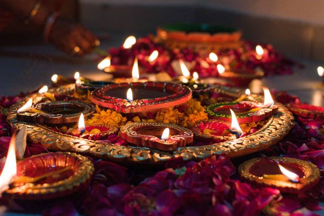 Combination of diyas and candles layed out beautifully for Diwali.