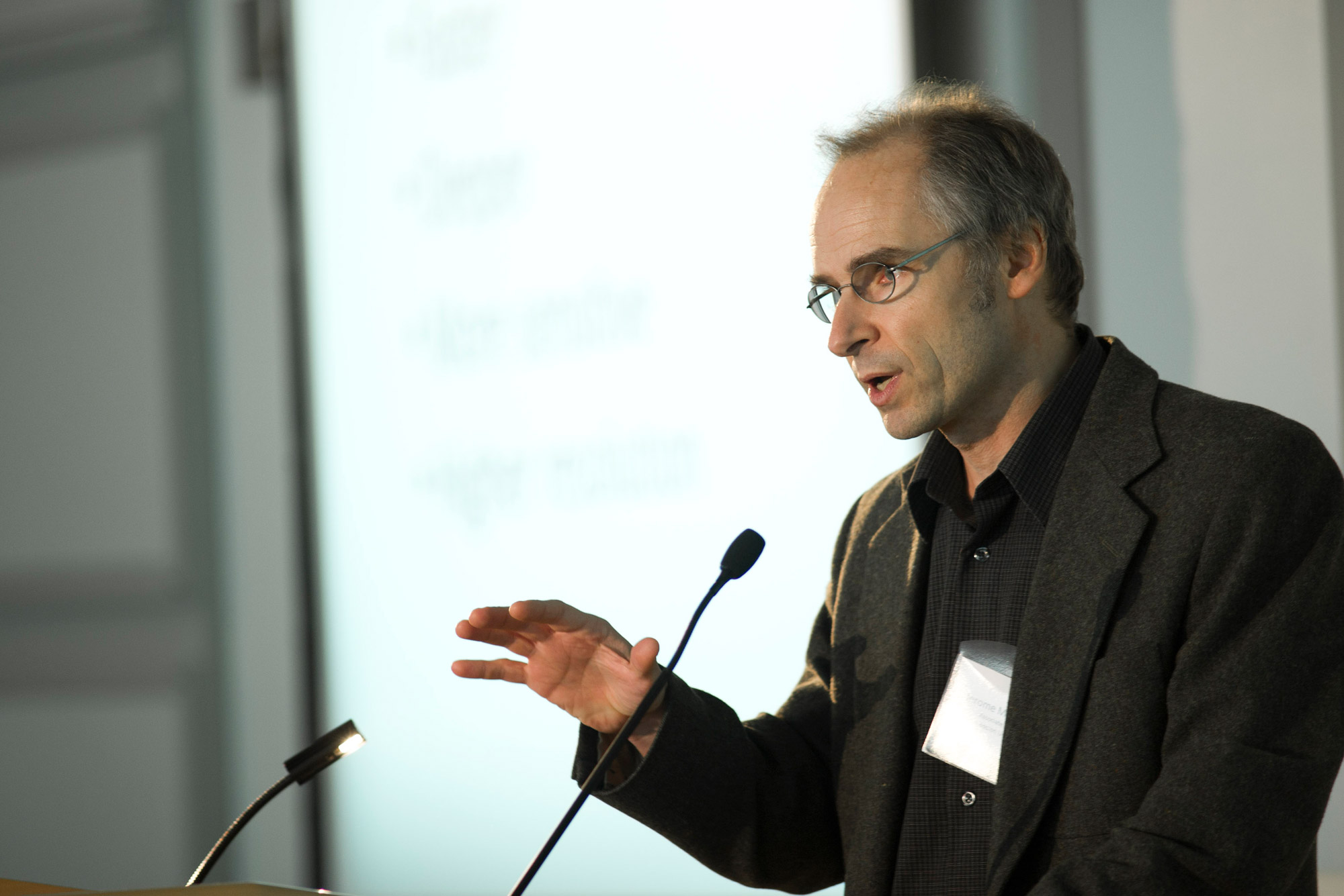 A photo of Jerome Mertz speaking at a podium