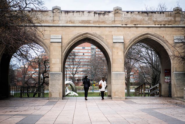 A photo of two people talking on Marsh Chapel