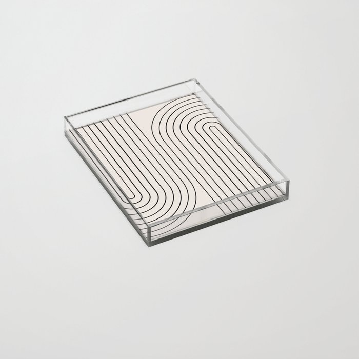 Photo of a clear organizing tray with a swirling black line design.