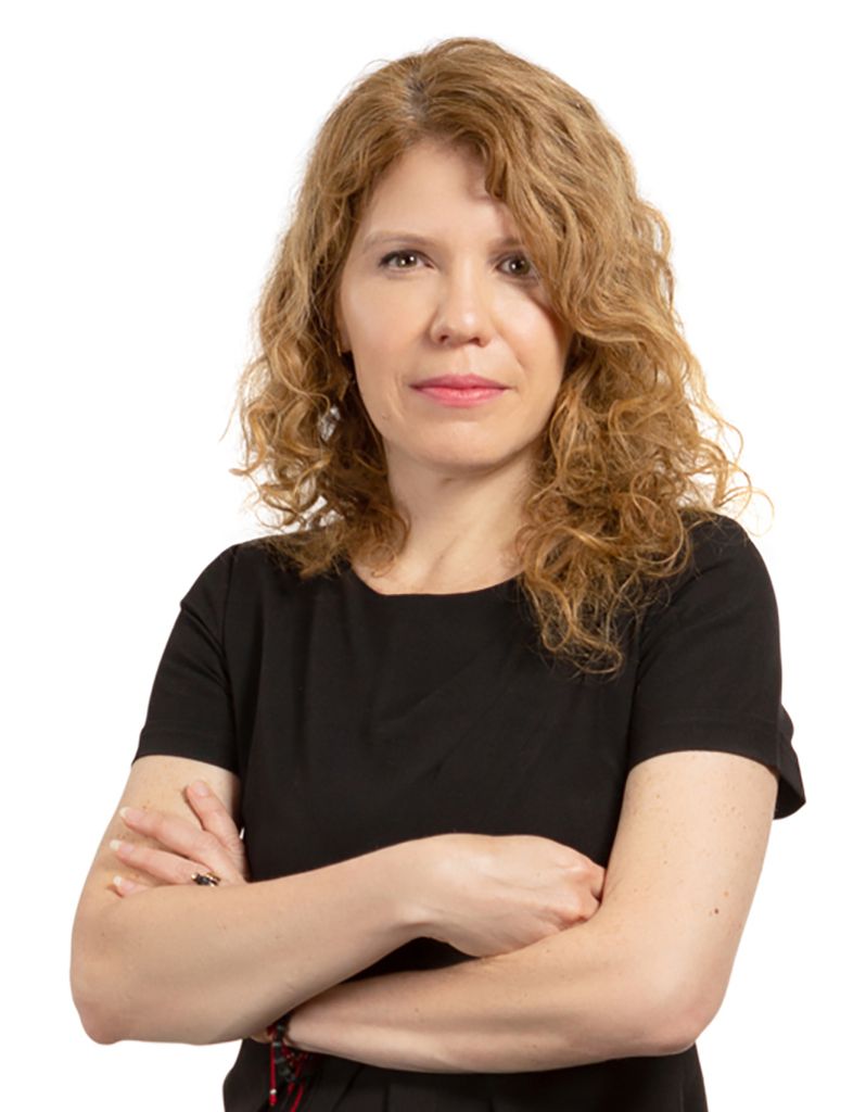 Portrait of LAW’s Karen J. Pita Loor on a white background; she wears a black dress and has her arms crossed.