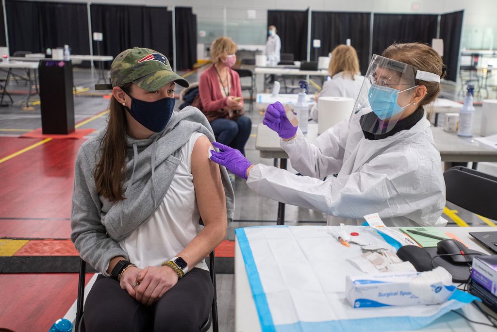 Athletic trainer Emily Gibb (SAR’10) receives the Moderna COVID-19 vaccine from Student Health Services Director of Nursing Anne Patey, MSN, at the vaccine clinic