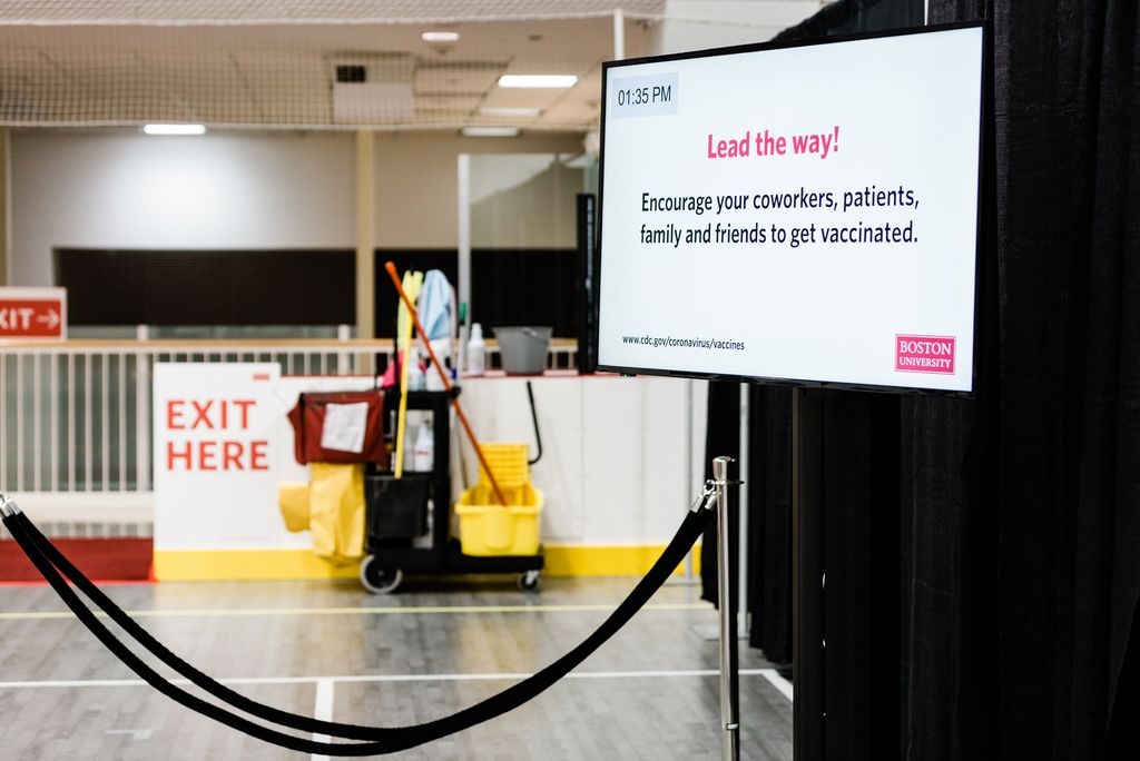A sign reading "Lead the Way: Encourage Your Coworkers, Patients, Family and Friends to get vaccinated."
