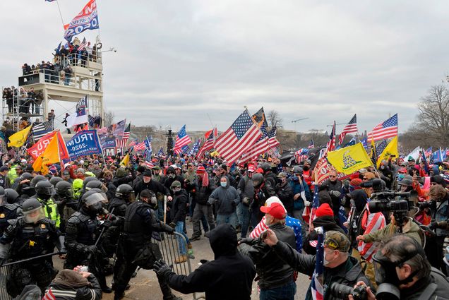 A photo of a mob of rioters clashing with police in front of the US Capitol on January 6, 2020