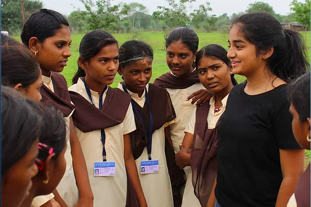 A photo of Sarina Zaparde talking with other girls wearing uniforms