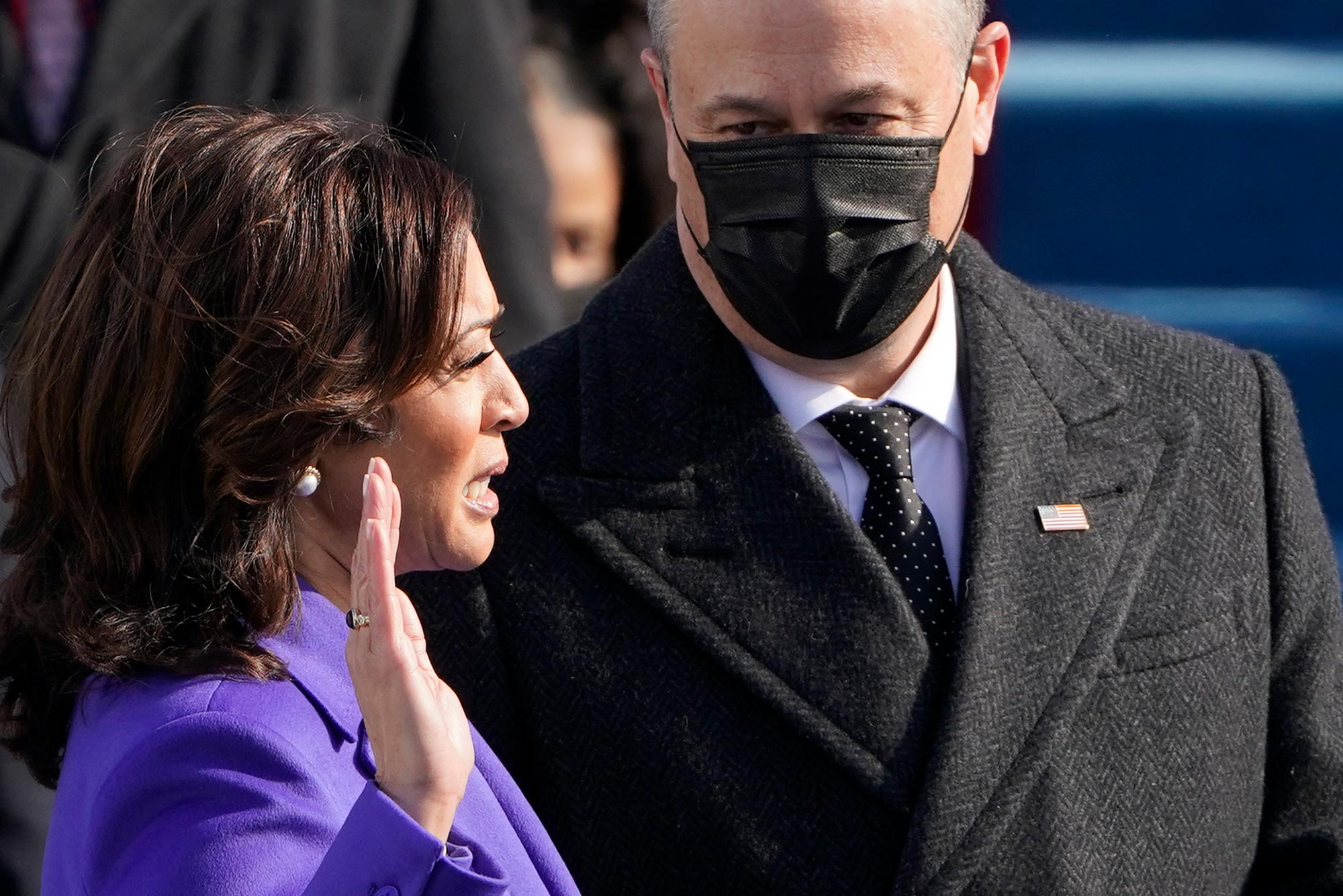 Photo of Kamala Harris raising her right hand as she is sworn in as vice president by Supreme Court Justice Sonia Sotomayor, her husband US Second Gentleman Doug Emhoff, wears a black mask, and holds the Bible, during the inauguration of Joe Biden as the 46th US President on January 20, 2021