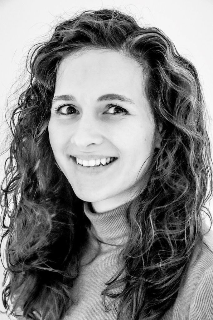 A portrait headshot of Rose Geer in black and white