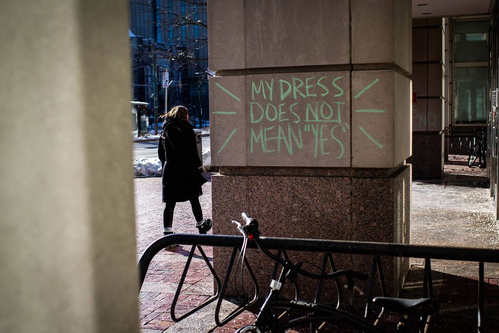 Photo of green chalk graffiti is seen on a column of one of the buildings on campus on February 8, 2021. The graffiti reads “my dress does not mean ‘yes’” with lines around it.