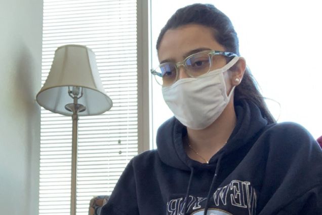 A photo of Manuela Luque wearing a mask in quarantine