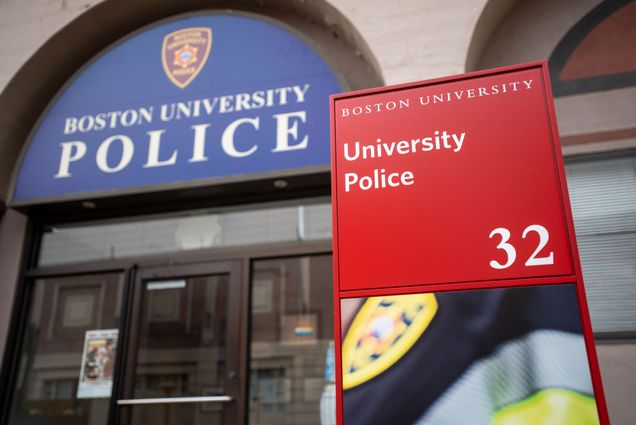 A photo of the facade of the Boston University Police Department. A sign reads "Boston University Police" and an address placard reads "Boston University, University Police, 32"