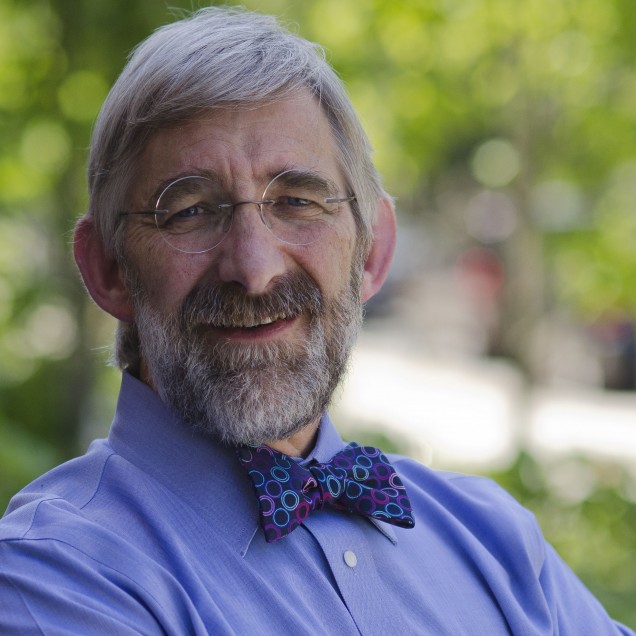 Headshot of Dennis Carlberg in a blue button down and a bow tie.