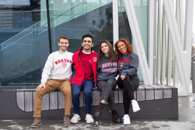 Photo of the BUnited team sitting on a bench. From left to right, Vice President of Finance: Shahaf Dan (CAS’22), Vice President Hessann Farooqi (CAS’22), President Nyah Jordan (CGS’20, COM’22), and Vice President, Internal Affairs: Aimee Mein (COM’22). Each student wears some kind of BU swag.