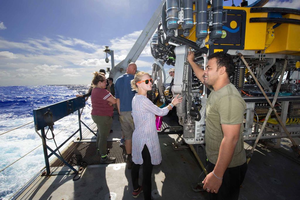 Anna Gauthier and Aranteiti Tekiau talk next to the deep sea submersible ROV SuBastian on the deck of the R/V Falkor sailing in the Phoenix Islands Protected Area.