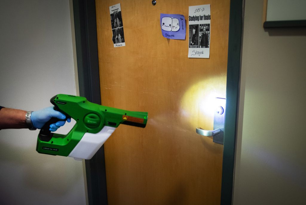 A photo of a BU custodian cleaning a residence hall.