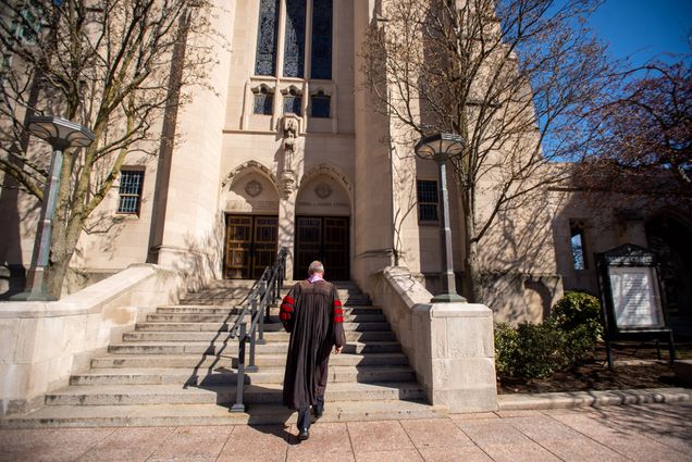 Rev. Dr. Robert Alan Hill walks up the steps of Marsh Chapel