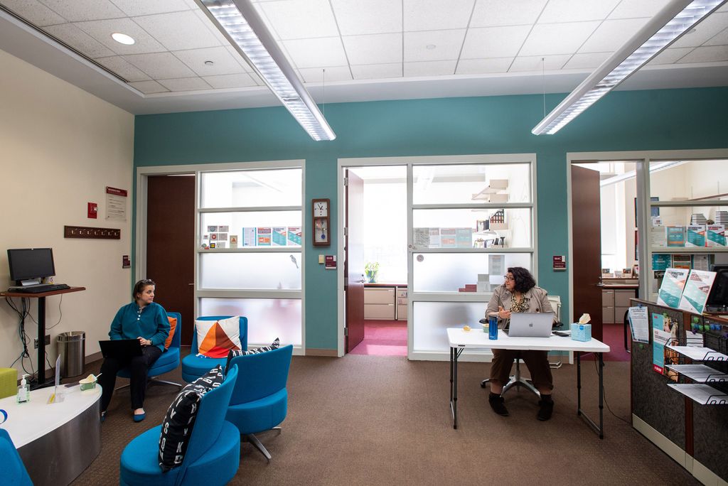 A photo of Meredith Siegel and Rachel Reiser practicing social distancing while working in their office.