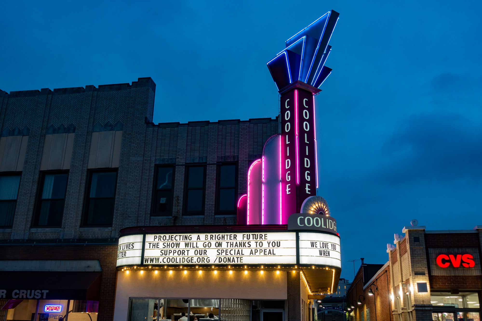 The marquee of the Coolidge Corner Theatre in Brookline, MA lit up at night.