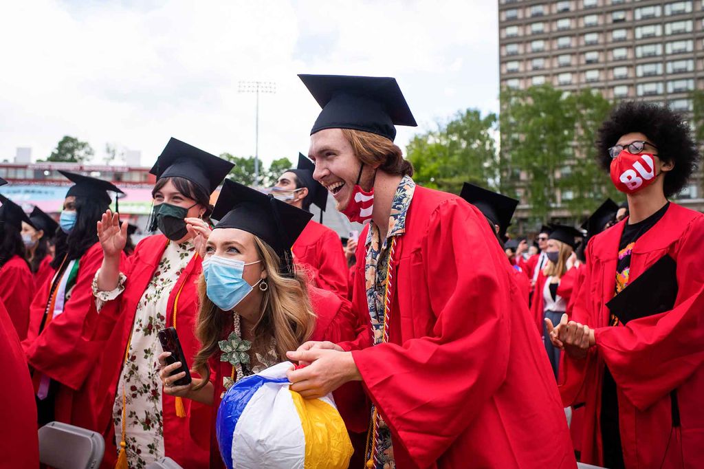 Graduates laugh during the 2021 BU Commencement ceremony.