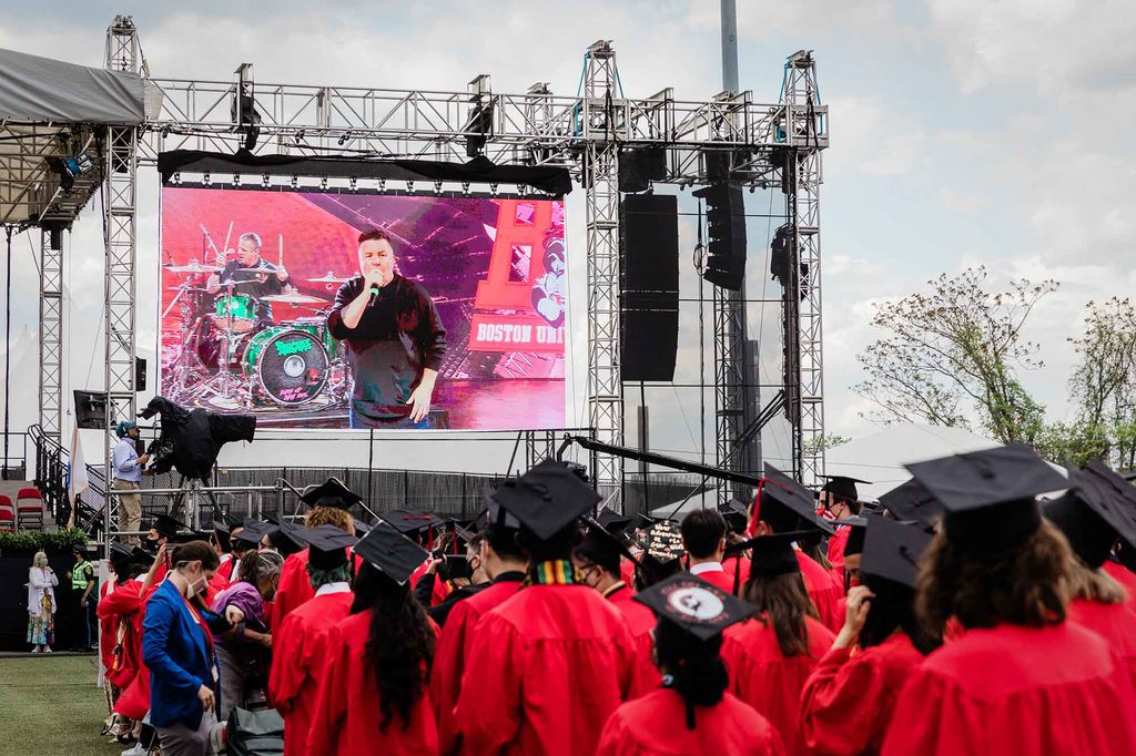 View of the screen next to the stage showing Dropkick Murphys performing a special set for BU Commencement.