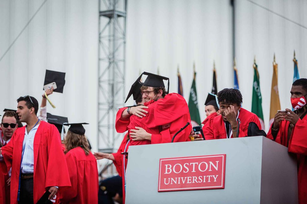 Graduates celebrate on the stage following the 2021 BU Commencement ceremony for undergradte degrees.