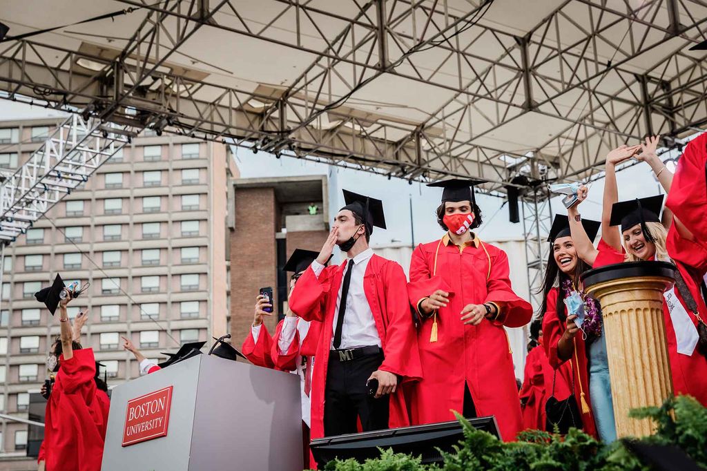 Graduates celebrate on the stage following the 2021 BU Commencement ceremony for undergradte degrees.