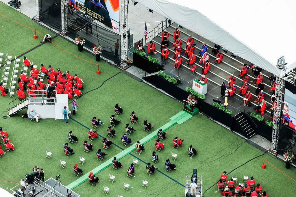 Aerial view of graduating students and the stage on Nickerson Field during Boston University's 148th Commencement. Seats were spaced out as a social distancing measure.