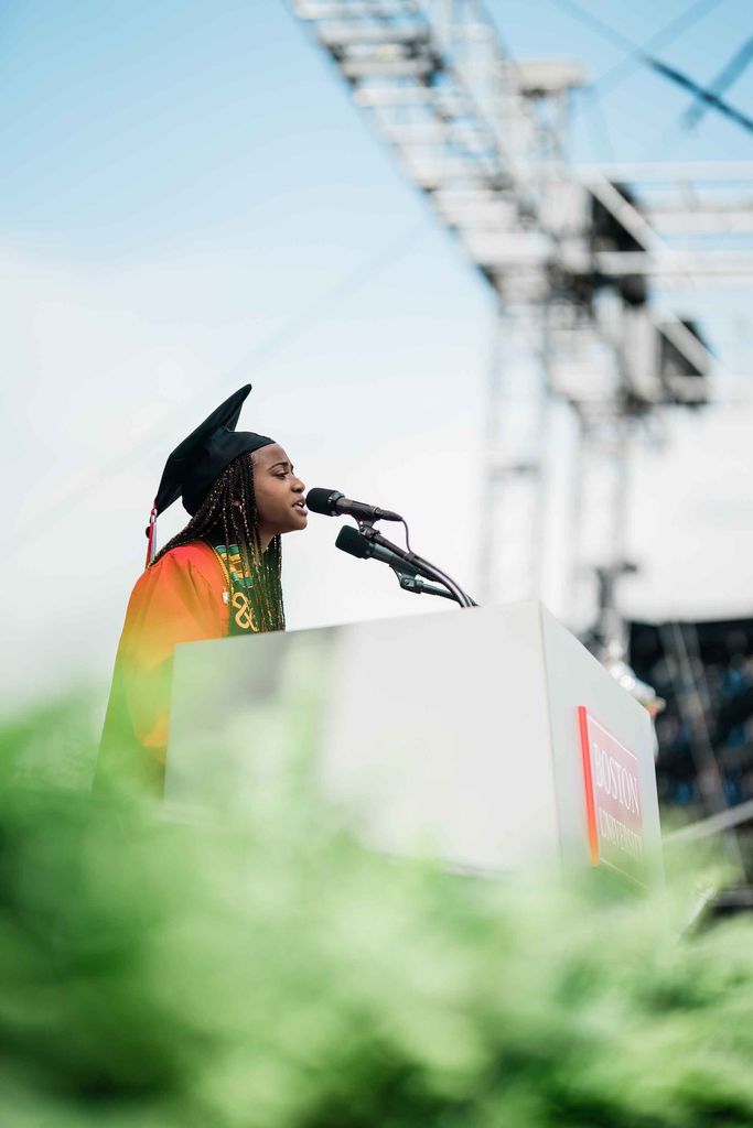 Side view of student speaker Archelle Thelemaque addressing graduating seniors at the 2021 BU Commencment ceremony for undergraduate degrees.