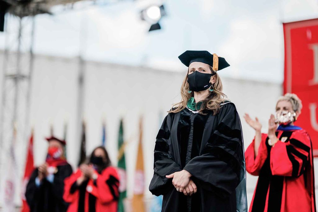 Director of BU Student Health Services Judy Platt stands on the stage during the 2021 BU Commencement.