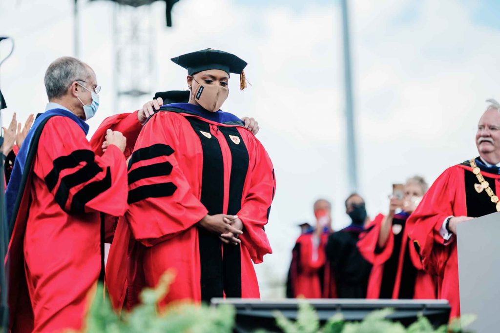 US Representative in Congress Ayanna Pressley is adorned with a stole while being awarded an Honorary Degree during the 2021 BU Commencment ceremony on Nickerson Field.